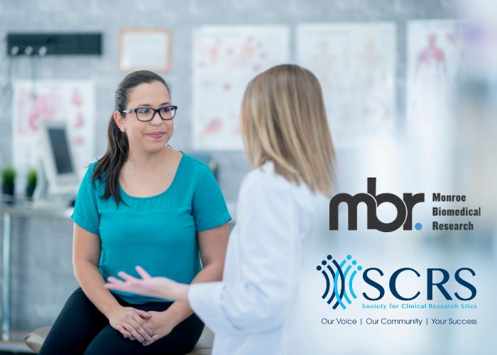 A patient consulting with a researcher for clinical trials in a medical facility.